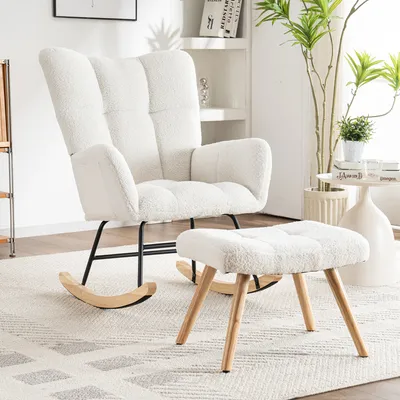A white fluffy rocking chair and ottoman are displayed on a rug in a room.