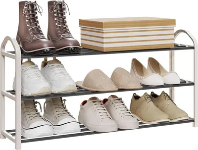 A three-tier shoe rack with various shoes and a decorative box on top.