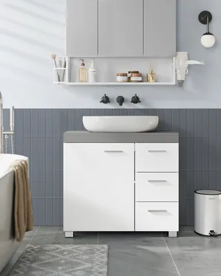 A modern bathroom vanity with a sink and storage.