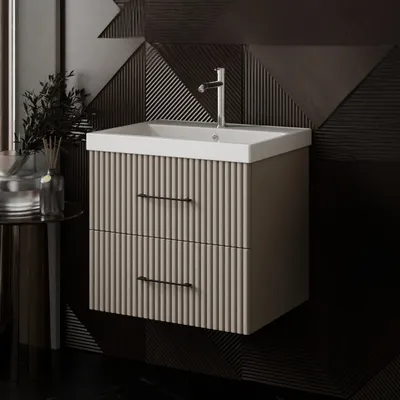 A modern bathroom vanity with a sink and faucet, set against a textured dark wall.