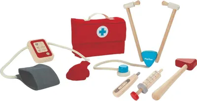 A set of wooden toy medical instruments, including a doctor's bag, stethoscope, blood pressure monitor, thermometer, syringe, and reflex hammer, arranged on a white background.
