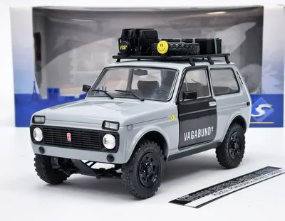 Immagine prodotto di Solido 421181540 Lada Niva Vlada 1980 grigio con bagaglio sul tetto 1:18