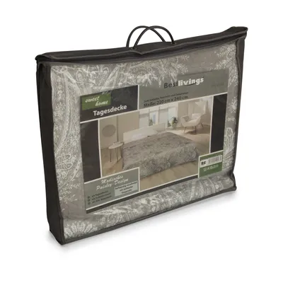 A product packaged in a clear plastic bag with handles, showing a printed design of a bed with a blanket.