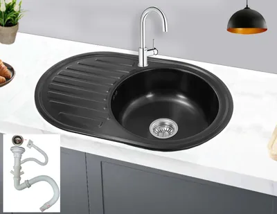 A black kitchen sink with a chrome faucet is shown on a white countertop, with a small inset image of plumbing parts.