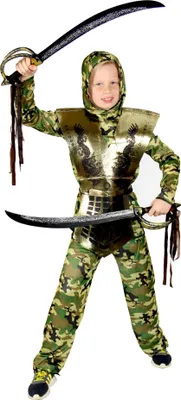 A child wearing a camouflage ninja costume with gold armor and holding two swords.