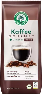 A bag of coffee beans with a glass of coffee.