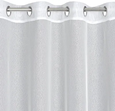 A close-up view of a white sheer curtain with metal grommets at the top.