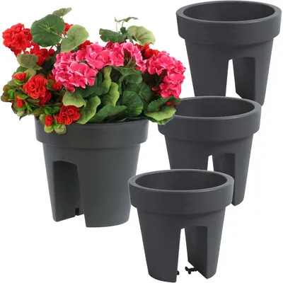 A set of four dark gray balcony planters, one of which is filled with red and pink flowers.