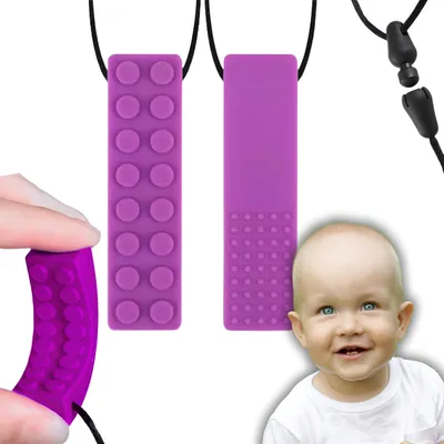 A baby is shown smiling next to two purple teething toys.