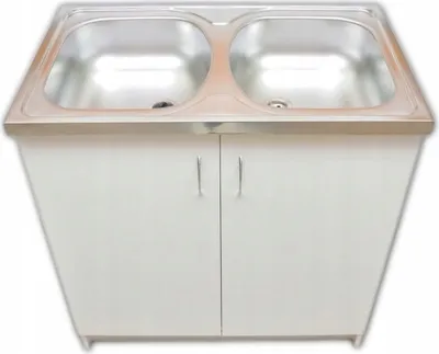 A double basin kitchen sink unit with white cabinet doors.