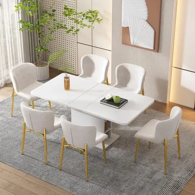 A dining set with a white table and six beige chairs with gold legs, set in a modern dining room.