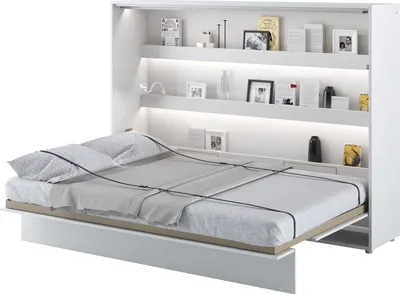 A white murphy bed is partially open, revealing the mattress and bedding. Shelves with decor are visible above the bed.
