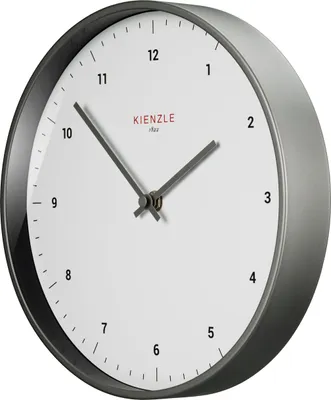 A close-up, angled view of a white analog wall clock with a gray frame.