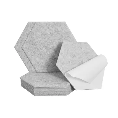 A stack of hexagonal acoustic panels, with one panel peeling off its adhesive backing.