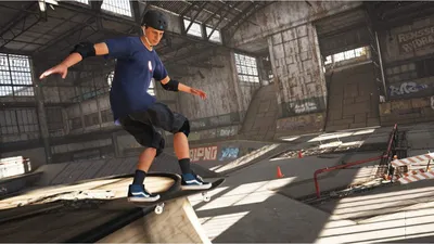 A skateboarder performing a trick in an indoor skatepark.