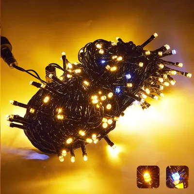 A tangled bundle of warm white and blue LED string lights on a yellow and gray background.