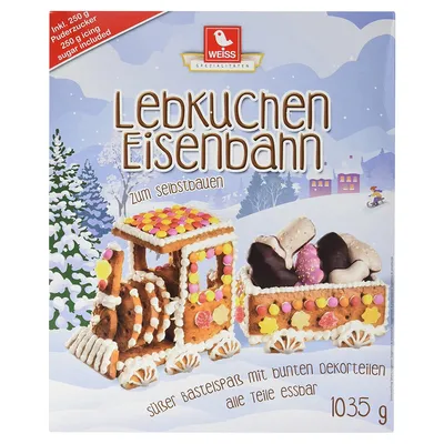 A box of gingerbread train building kit in a winter scene.