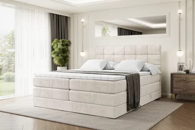 A bedroom scene with a large bed as the focal point.