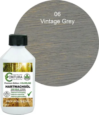 A bottle of wood oil with a sample of the finished wood color.