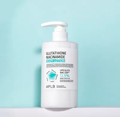 A white pump bottle of body lotion is displayed against a light blue and white background.