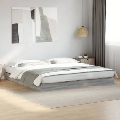 A bed frame with bedding in a bedroom.