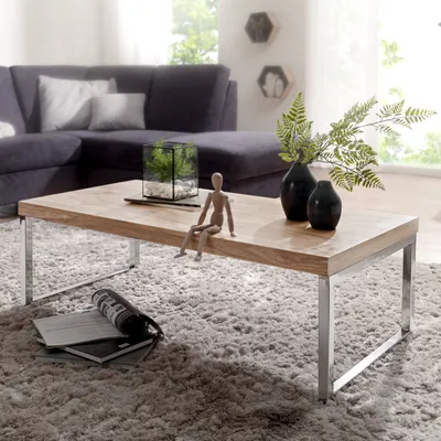 A living room scene with a couch, coffee table, and rug.