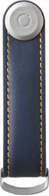 A product shot of a navy leather key organizer with tan stitching and a silver top.