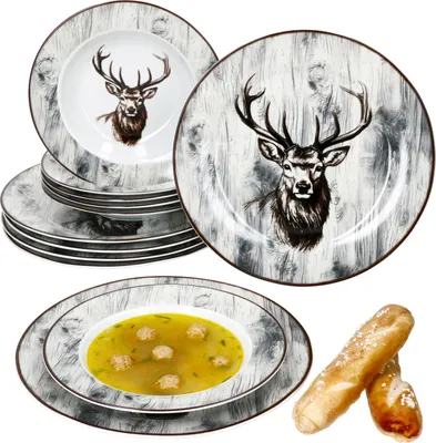 A set of dinnerware with a deer motif, including plates and a soup bowl with food, along with breadsticks.