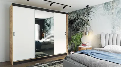 A bedroom scene with a large wardrobe and a bed.