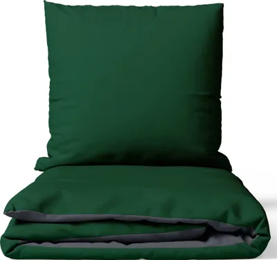 A dark green duvet cover and pillowcase are neatly folded.