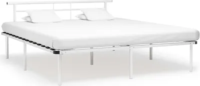 A white metal bed frame with a mattress and two pillows.