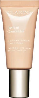 A product shot of a Clarins Instant Concealer tube with a gold cap.