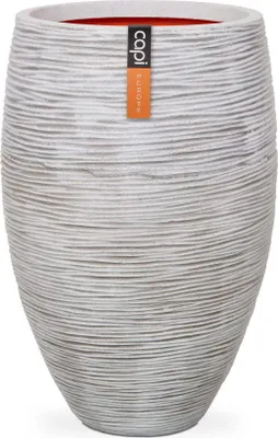 A tall, textured planter pot with a label attached.