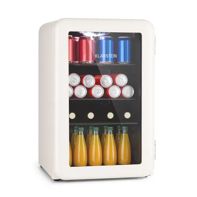 A white mini-refrigerator filled with drinks, including cans and bottles of juice, against a white background.