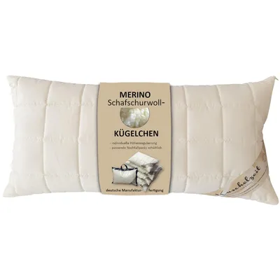A cream-colored pillow with a label attached.