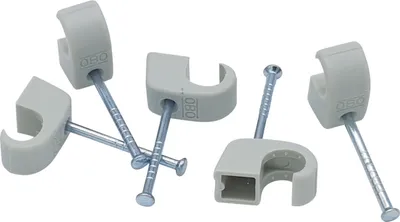A group of cable clips with nails on a white background.