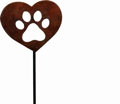 A garden stake in the shape of a heart with a paw print cut-out, made of rusted metal.