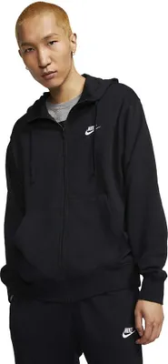 A man wearing a black Nike hoodie and black sweatpants.