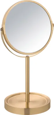 A gold-colored makeup mirror on a stand.