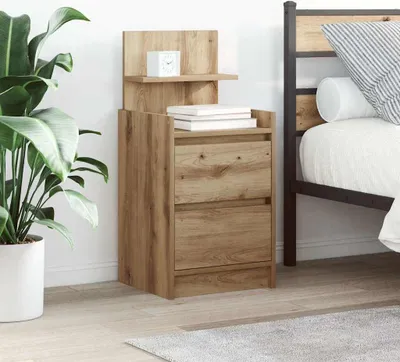 A wooden nightstand with two drawers is placed next to a bed. A large potted plant is on the left side of the nightstand.