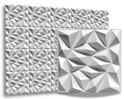 A display of white 3D wall panels with a geometric, faceted design. One panel is shown in close-up to the right of a larger arrangement of panels.