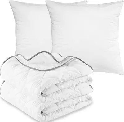 A set of bedding including two pillows and a folded comforter, all white with gray trim.