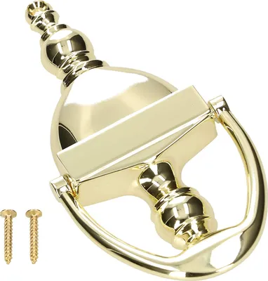 A golden door knocker and two screws on a white background.