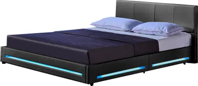A black upholstered bed frame with blue LED lighting around the base and two light blue pillows on the mattress.