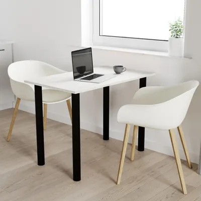 A white table with black legs, two white chairs, a laptop, and a mug, set in a bright, minimalist room with a window.