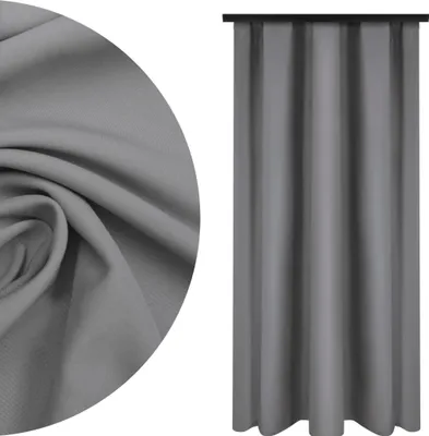 A close-up of gray fabric and a gray curtain hanging.