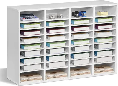 A white multi-compartment organizer filled with various office supplies and binders.