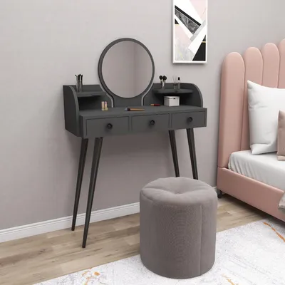 A vanity table with a mirror and stool in a bedroom setting.