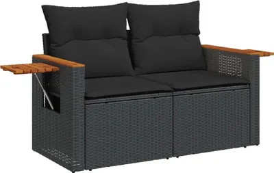 A black two-seater outdoor sofa made of poly rattan with wooden armrests and a small wooden table attached to one side.