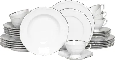 A collection of white porcelain dinnerware with silver trim, including plates, bowls, and cups.